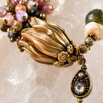 Macro detail of Tulipe bracelet featuring Vintaj brass tulip focal, watermelon tourmaline gemstones, and crystal drop charm.