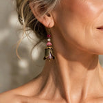 Woman wearing Tulipe Earrings with Czech crystal blossoms and Vintaj brass tulip petals in an elegant editorial close-up portrait.