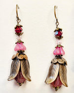 Close-up of Tulipe Garden Reverie Earrings featuring layered brass petals, pink glass flowers, and deep berry Austrian crystals — handmade by Carabella by Cheryl.