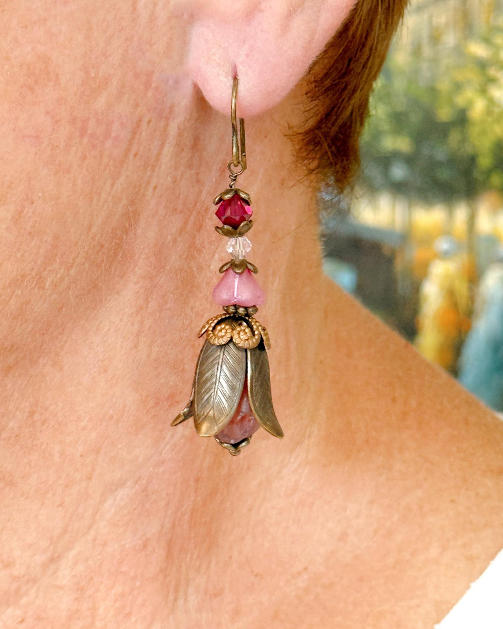 Model wearing the Tulipe Garden Reverie Earrings, showcasing the vintage brass petals, pink floral glass beads, and romantic Garden Reverie design by Carabella by Cheryl.