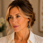 Woman wearing Venezia handcrafted Murano glass drop earrings with sterling silver in an elegant portrait.
