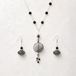 Venezia Murano glass necklace and matching drop earrings styled together on Carabella white quartz in a luxury flat lay.