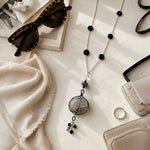 Venezia Murano glass necklace styled in an elegant lifestyle flat lay with refined accessories on a premium marble surface.