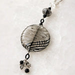 Close-up of the handcrafted Venezia Murano glass pendant showing authentic Venetian glass artistry, sterling silver components and crystal tassel detail.