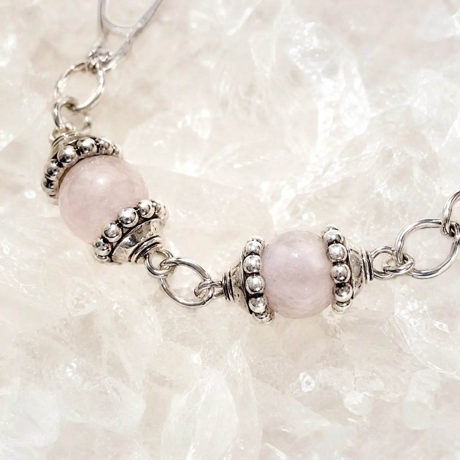 Macro detail of the Venus Bracelet highlighting rose quartz and moonstone gemstones, sterling silver bead caps, and handcrafted craftsmanship.