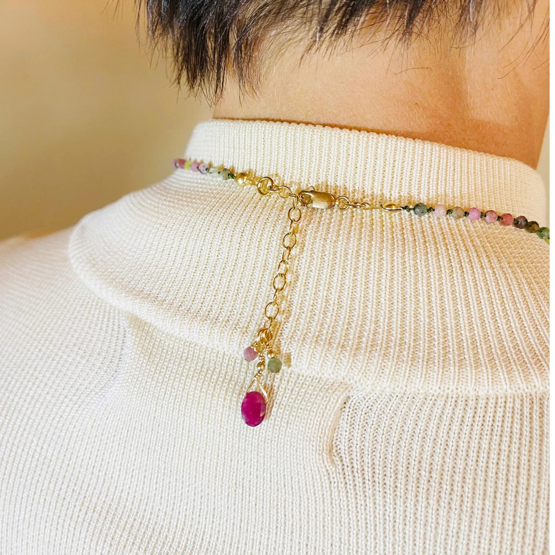 Close up view of the Layla Gemstone Necklace clasp and extension chain featuring coordinating tourmaline and ruby accents.